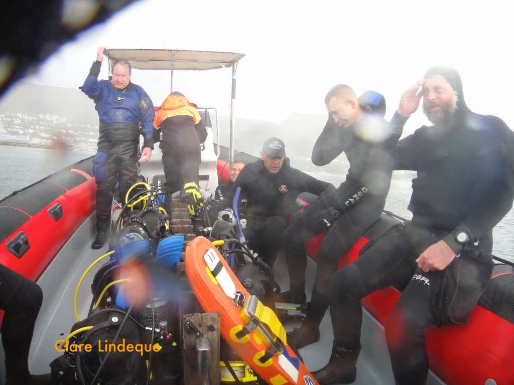 Gerard and Cecil crouch inside the boat to escape the spray