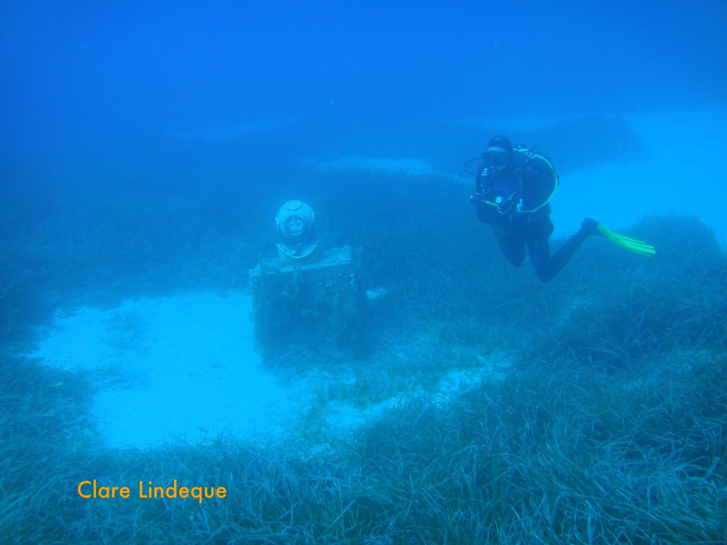 Divemaster Sergey hovers near the statue