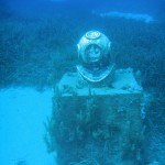 The helmet rests on a plinth, raising it off the seabed