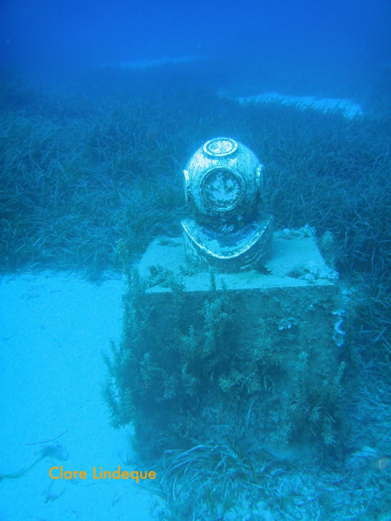 The helmet rests on a plinth, raising it off the seabed